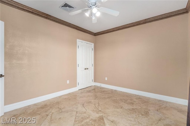 empty room with marble finish floor, crown molding, visible vents, a ceiling fan, and baseboards