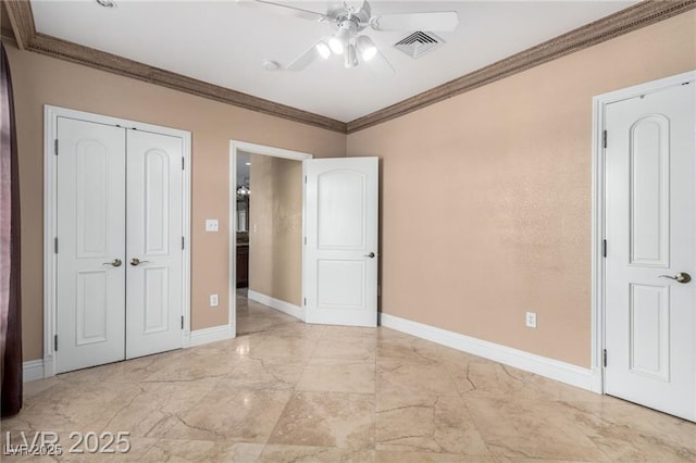 unfurnished bedroom featuring baseboards, visible vents, ornamental molding, marble finish floor, and a closet