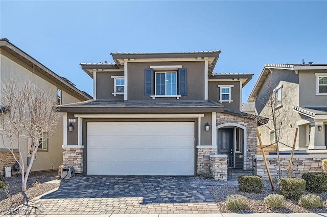 view of front of property with stone siding, decorative driveway, and stucco siding