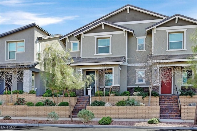 view of front of home featuring a tile roof and stucco siding