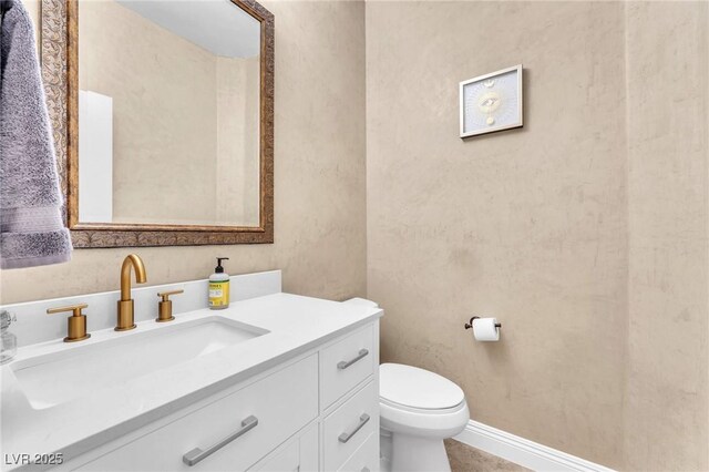 bathroom with toilet and vanity