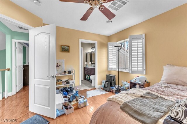 bedroom with visible vents, baseboards, a ceiling fan, and wood finished floors