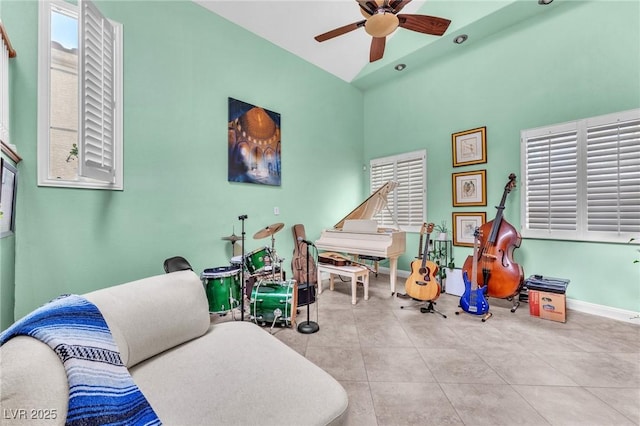 recreation room with baseboards, ceiling fan, and tile patterned flooring