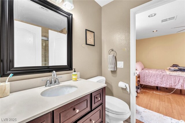 full bath with visible vents, toilet, ensuite bath, and vanity