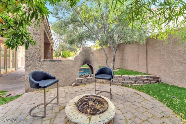 view of patio / terrace with a fenced backyard and an outdoor fire pit