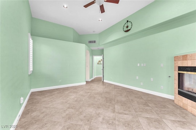 8629 Estrelita Dr, Las Vegas, NV 89128 - unfurnished living room with a tile fireplace, a ceiling fan, baseboards, and a high ceiling