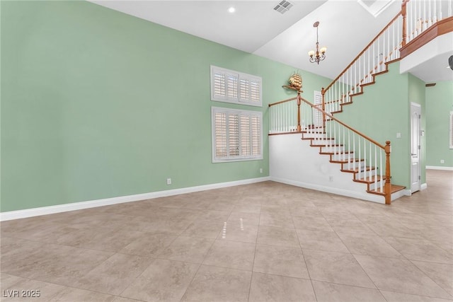 8629 Estrelita Dr, Las Vegas, NV 89128 - unfurnished living room with stairs, a chandelier, tile patterned flooring, baseboards, and a towering ceiling
