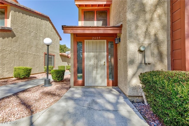 entrance to property with stucco siding