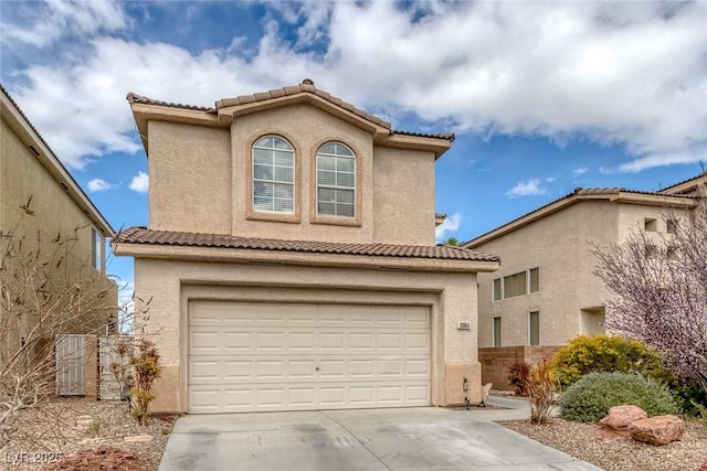 view of front of house featuring stucco siding, driveway, a tile roof, and a garage