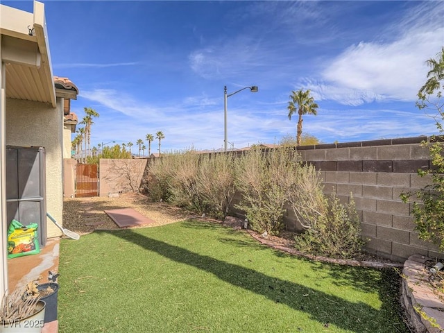 view of yard with a fenced backyard