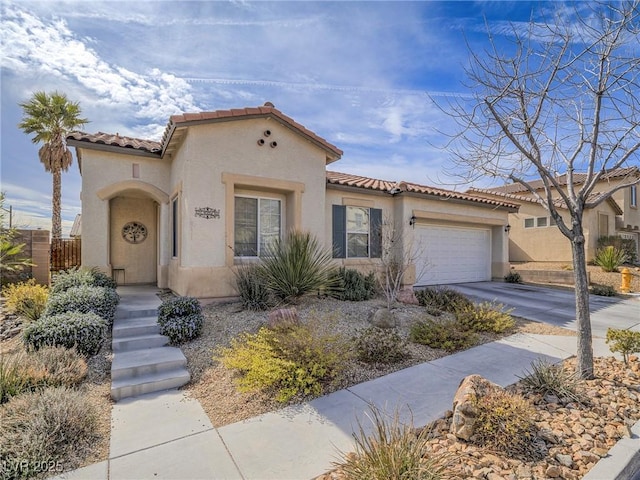 mediterranean / spanish-style house with a garage, driveway, a tile roof, and stucco siding