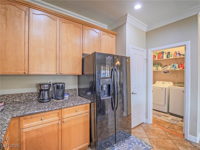 kitchen featuring recessed lighting, black fridge with ice dispenser, ornamental molding, dark stone countertops, and washer and dryer