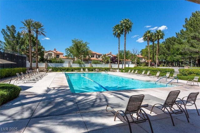 pool featuring fence and a patio