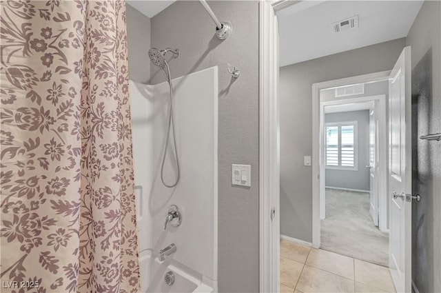 bathroom with baseboards, shower / bathtub combination with curtain, visible vents, and tile patterned flooring