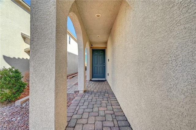 entrance to property with stucco siding