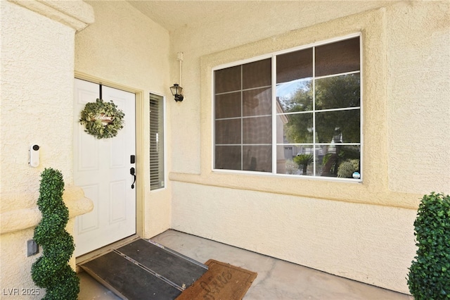 entrance to property featuring stucco siding