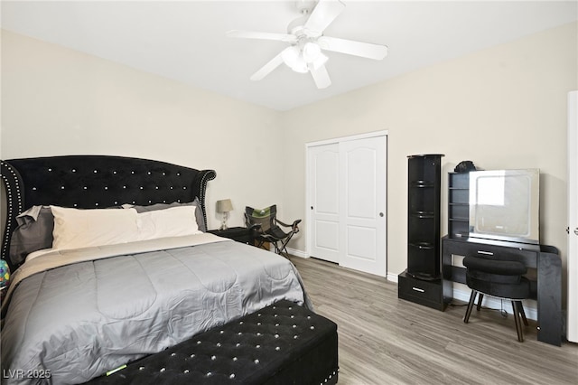 bedroom featuring a closet, ceiling fan, baseboards, and wood finished floors