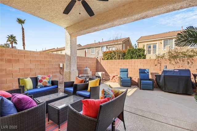 view of patio with a fenced backyard, ceiling fan, an outdoor living space, and grilling area