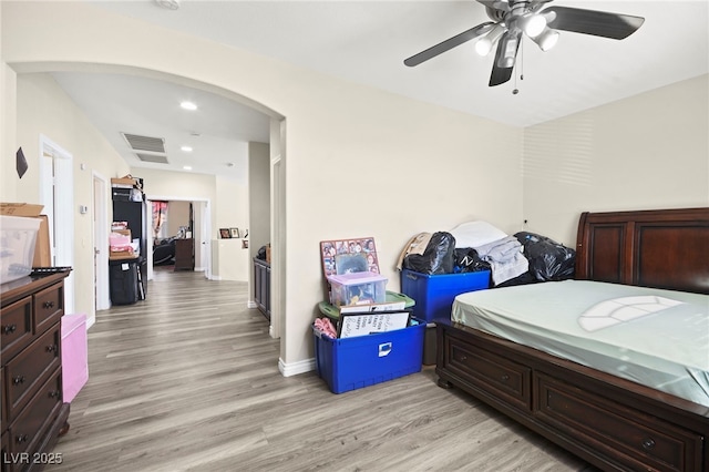 bedroom with visible vents, arched walkways, light wood-style flooring, ceiling fan, and recessed lighting