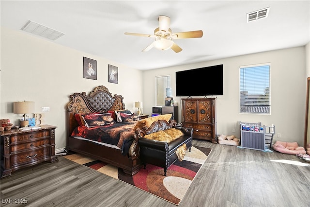 bedroom featuring visible vents, ceiling fan, and wood finished floors