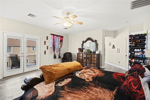 bedroom featuring access to exterior, french doors, visible vents, and light wood-style flooring