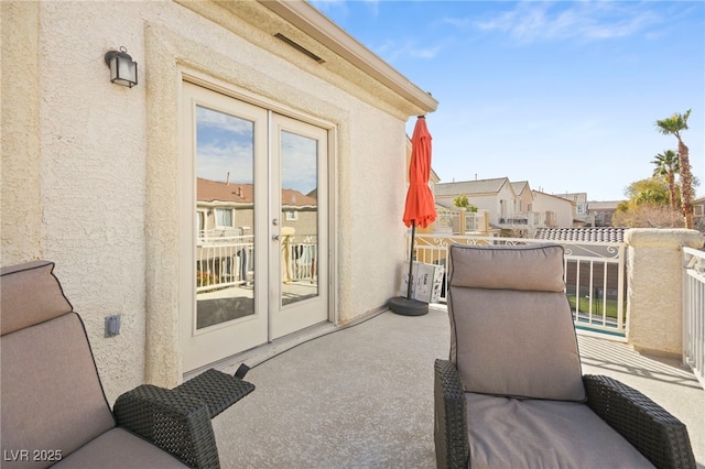 balcony with french doors and a residential view