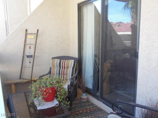 entrance to property featuring stucco siding