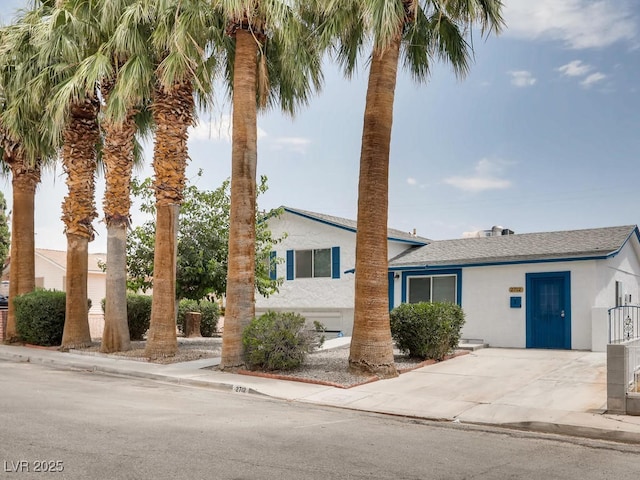 tri-level home with stucco siding