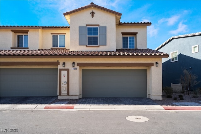 view of front of house with an attached garage and stucco siding