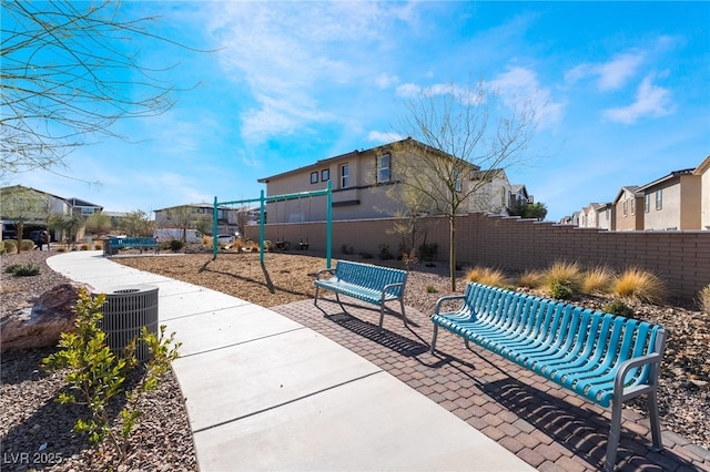 view of patio / terrace with a residential view, fence, and playground community