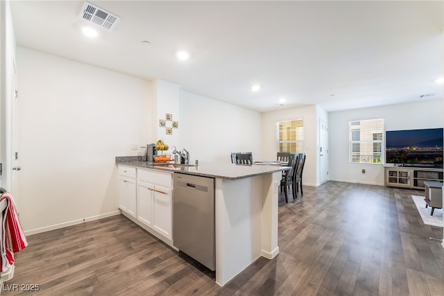 kitchen featuring stone counters, visible vents, white cabinetry, open floor plan, and dishwasher