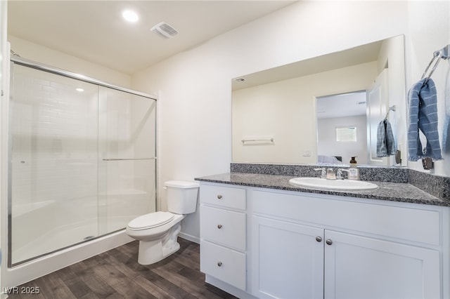 ensuite bathroom with toilet, ensuite bath, wood finished floors, vanity, and a shower stall