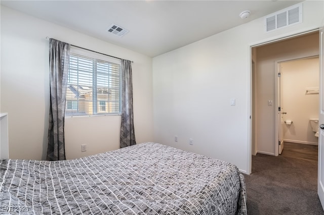 bedroom with dark colored carpet, visible vents, and baseboards