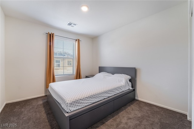 bedroom featuring dark carpet, visible vents, and baseboards