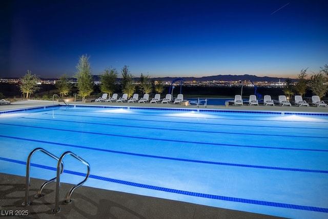 view of pool at dusk