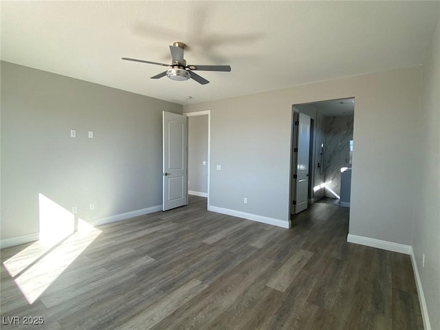 unfurnished room with ceiling fan, baseboards, and dark wood finished floors