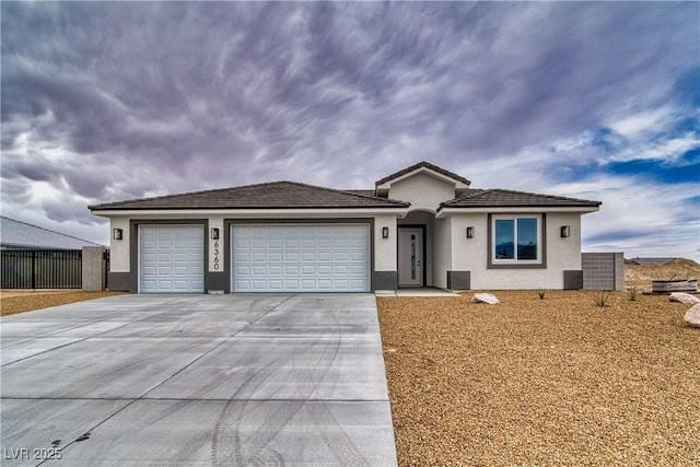 ranch-style house featuring stucco siding, concrete driveway, a garage, and fence