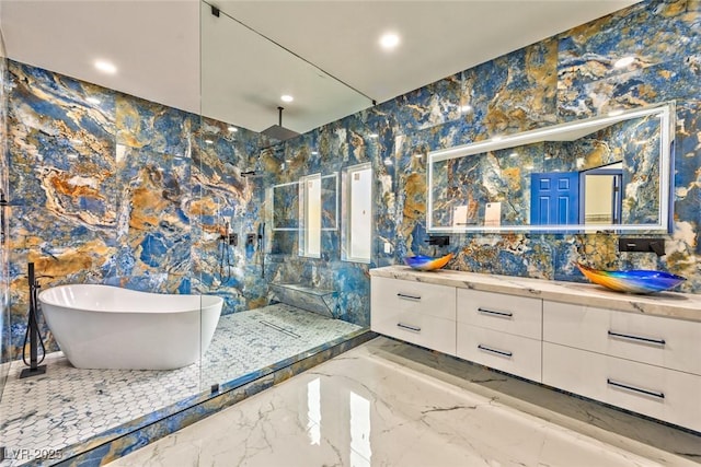 full bathroom featuring a walk in shower, a freestanding tub, recessed lighting, vanity, and marble finish floor