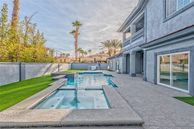 view of swimming pool featuring a fenced backyard and a pool with connected hot tub