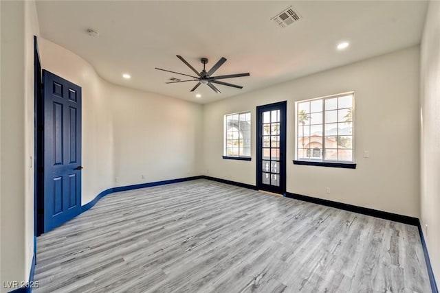 unfurnished room with recessed lighting, visible vents, light wood-style floors, a ceiling fan, and baseboards