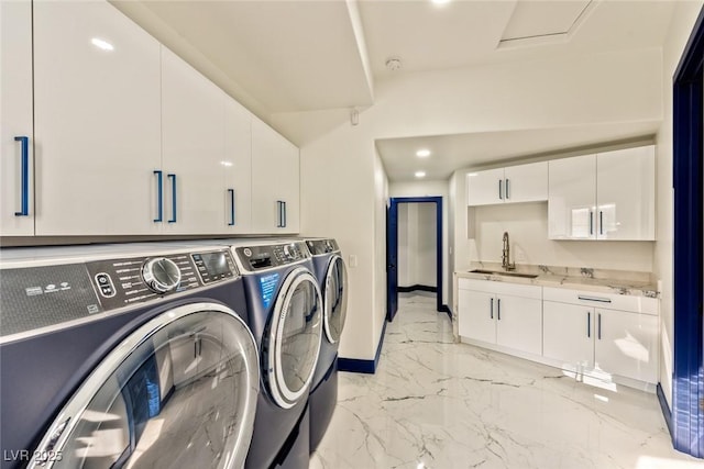 washroom with marble finish floor, cabinet space, a sink, independent washer and dryer, and baseboards