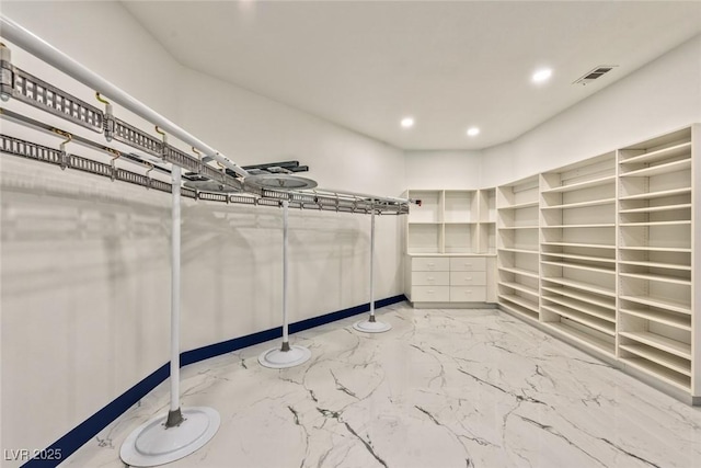 walk in closet featuring marble finish floor and visible vents