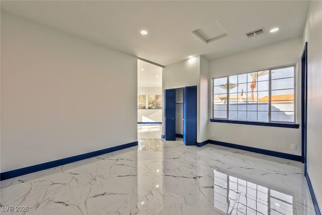 empty room featuring attic access, baseboards, visible vents, marble finish floor, and recessed lighting