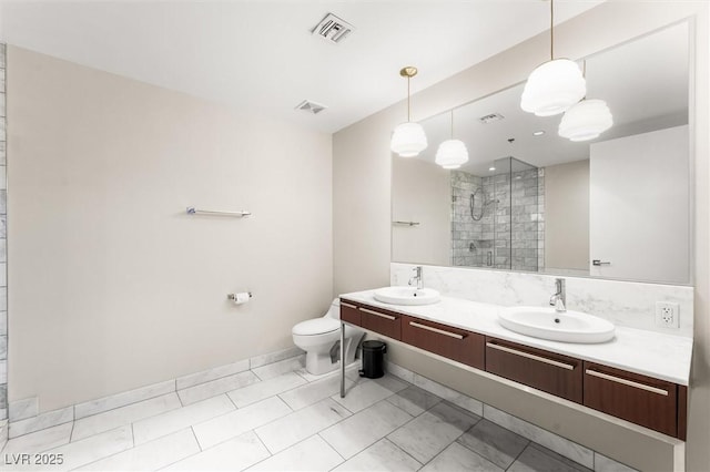 bathroom featuring a shower stall, visible vents, and a sink