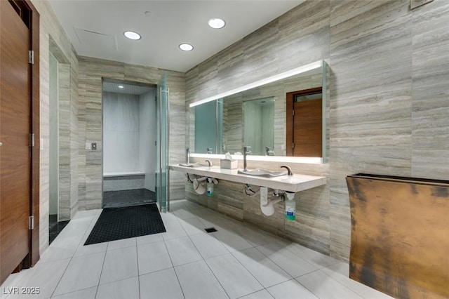 bathroom with tile patterned flooring, tile walls, and recessed lighting