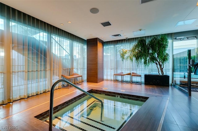 view of swimming pool with an indoor in ground hot tub