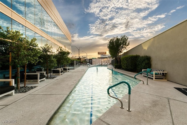 pool featuring a patio area and fence