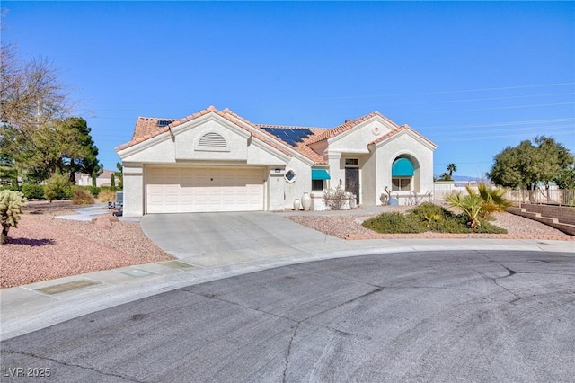 view of front of house with a garage, solar panels, driveway, a tiled roof, and stucco siding