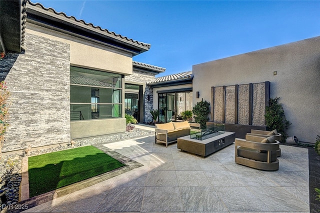 view of patio / terrace featuring an outdoor living space with a fire pit