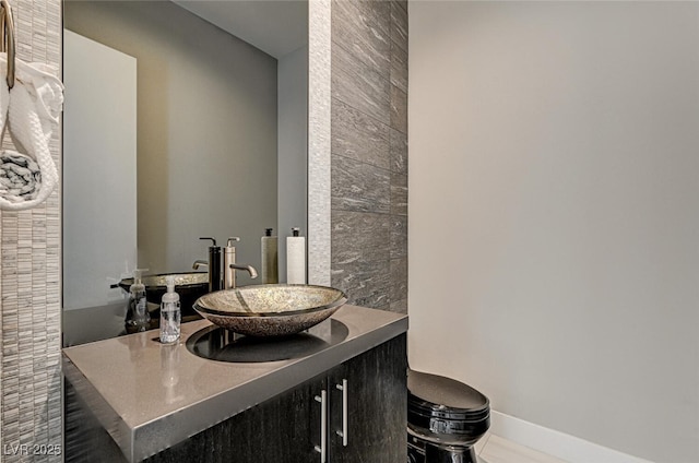 bathroom featuring vanity and baseboards